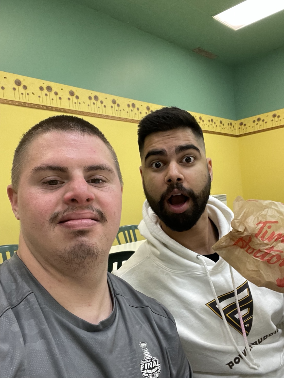 Two buddies taking a selfie during a snack break