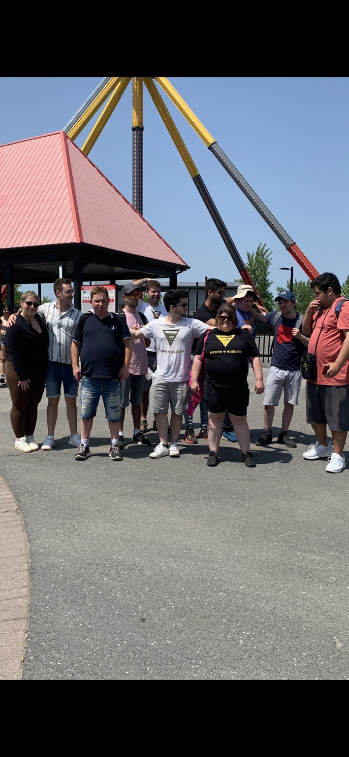 The Power Buddies group by the rides on a past La Ronde outing